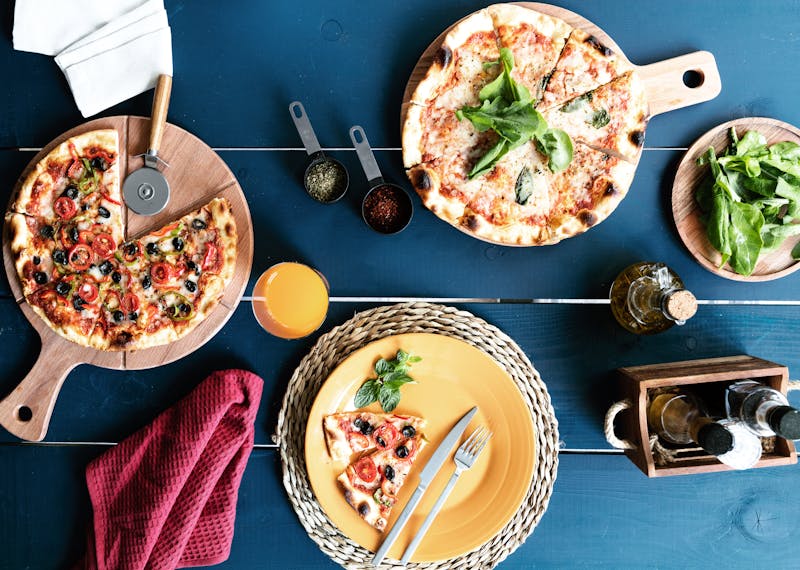 Professional catering team setting up pizza for an event